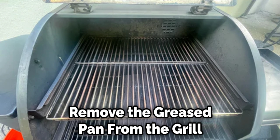 Remove the Greased Pan From the Grill