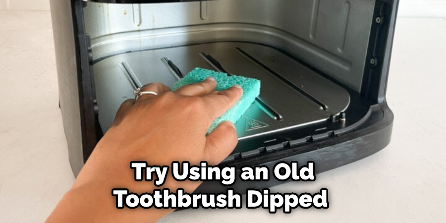 Try Using an Old Toothbrush Dipped 