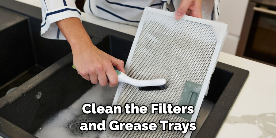 Clean the Filters and Grease Trays