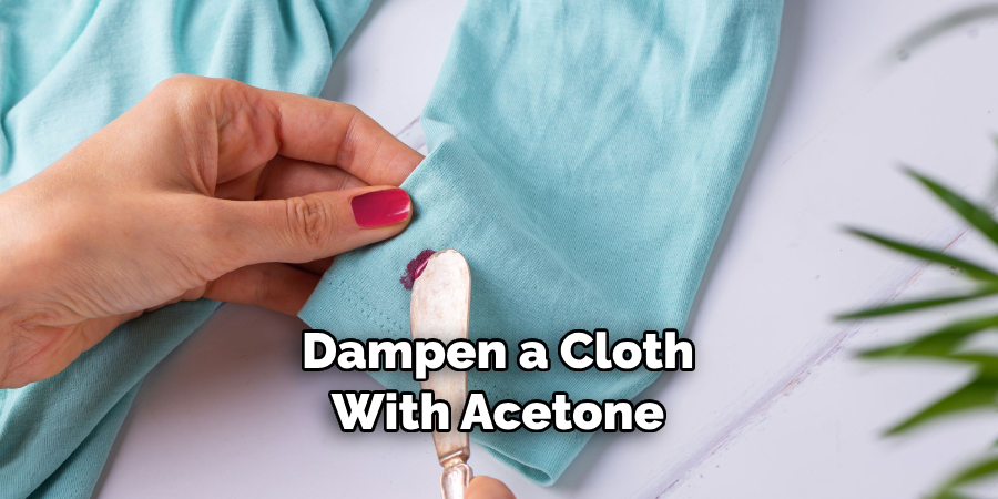 Dampen a Cloth With Acetone