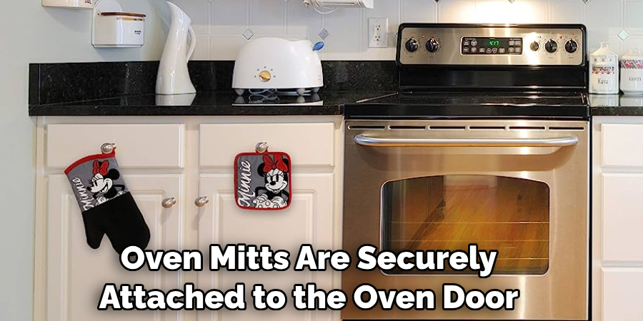 Oven Mitts Are Securely Attached to the Oven Door