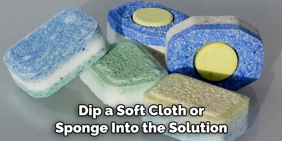 Dip a Soft Cloth or Sponge Into the Solution