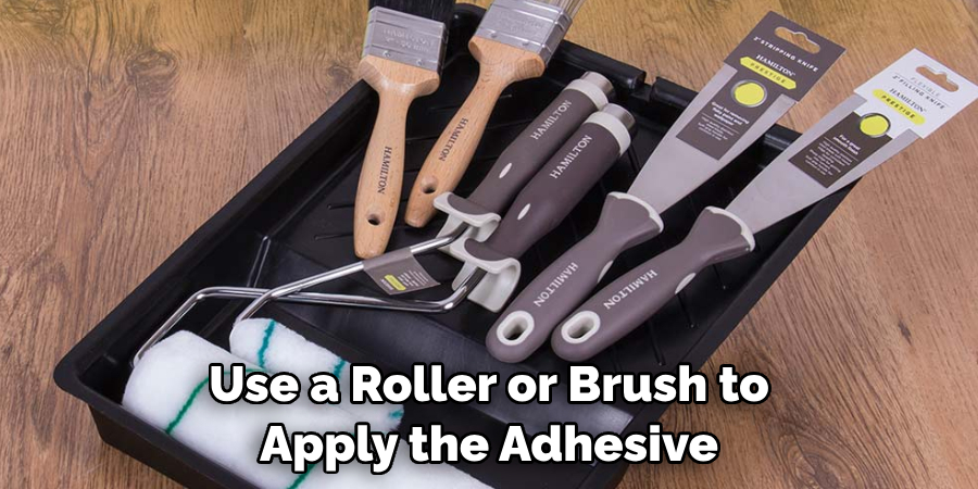 Use a Roller or Brush to Apply the Adhesive