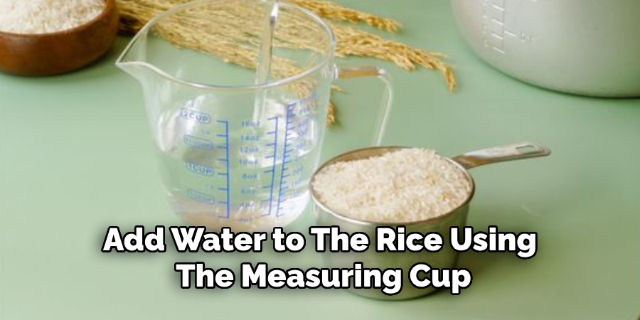 Add Water to the Rice Using the Measuring Cup