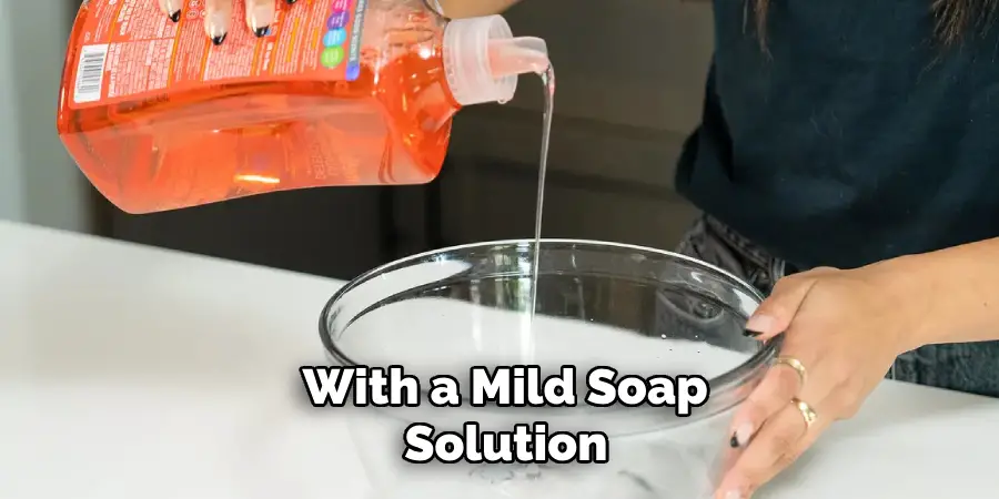 With a Mild Soap Solution