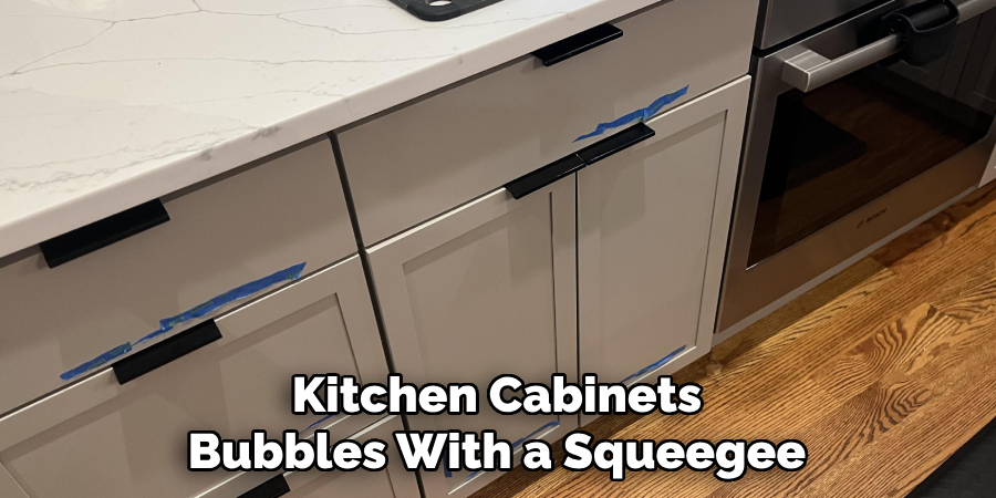 Kitchen Cabinets Bubbles With a Squeegee