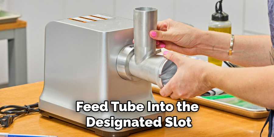 Feed Tube Into the 
Designated Slot